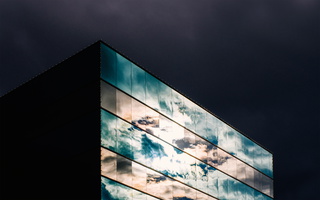 Cloudy sky reflected on glass building 21 s