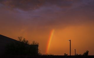 Desert Rainbow Against Orange Sky