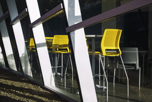 Three yellow chairs behind glass 1