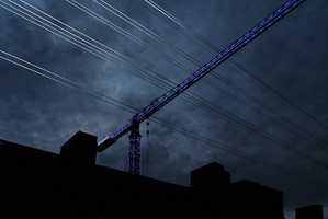 Different Xmas lights lit crane power lines